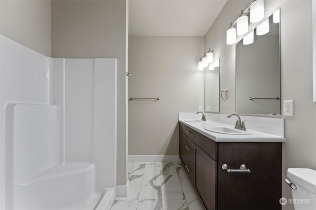 bathroom featuring vanity, toilet, and a shower