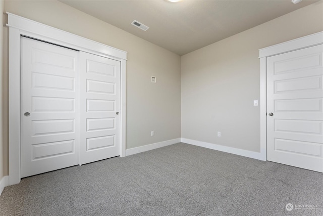 unfurnished bedroom featuring a closet and carpet floors