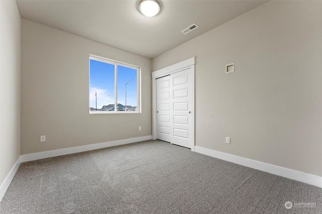 unfurnished bedroom featuring carpet flooring and a closet