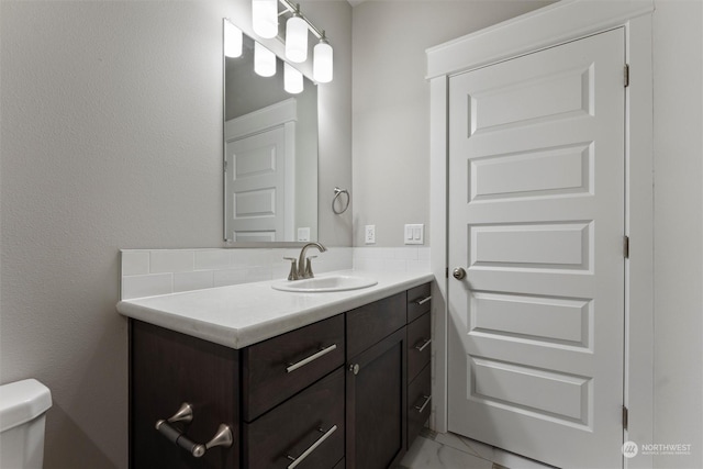 bathroom featuring vanity and toilet