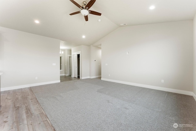 unfurnished room featuring light wood-type flooring, vaulted ceiling, and ceiling fan