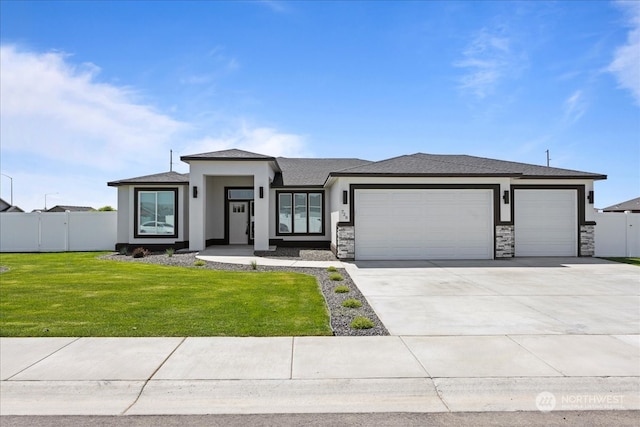 prairie-style home with a garage and a front yard