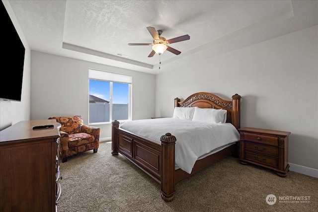 bedroom with visible vents, a raised ceiling, light colored carpet, and a textured ceiling