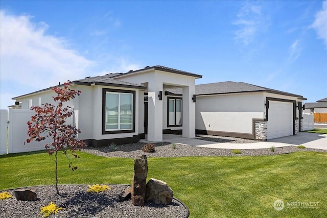 prairie-style home featuring stucco siding, fence, a garage, driveway, and a front lawn