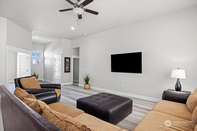 living room with light wood-type flooring and ceiling fan