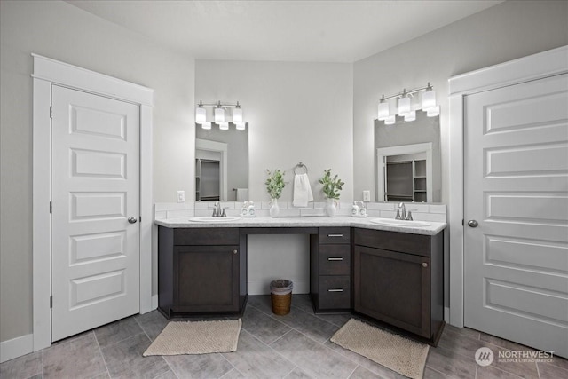 full bath featuring double vanity and a sink