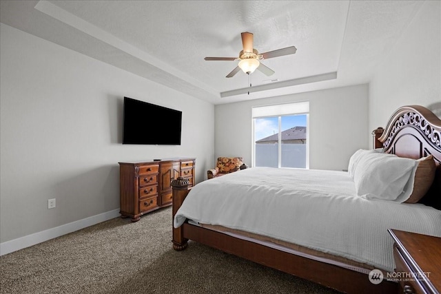 carpeted bedroom featuring a ceiling fan, a raised ceiling, visible vents, and baseboards