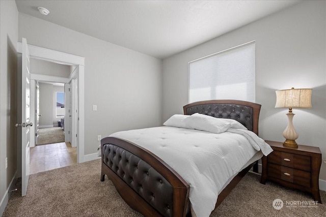 bedroom featuring carpet flooring and baseboards