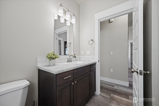 bathroom featuring hardwood / wood-style floors, toilet, and vanity