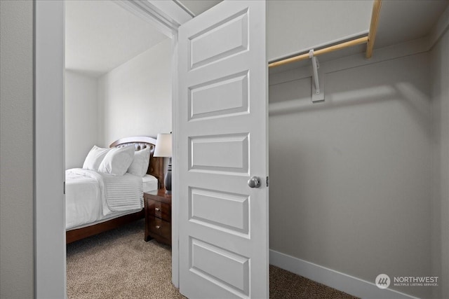 bedroom with carpet and baseboards