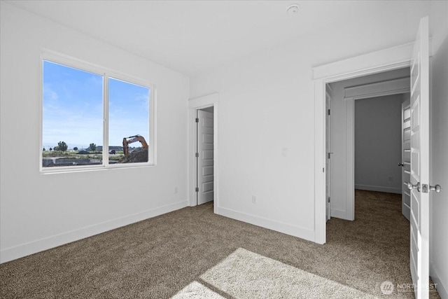 carpeted bedroom featuring baseboards