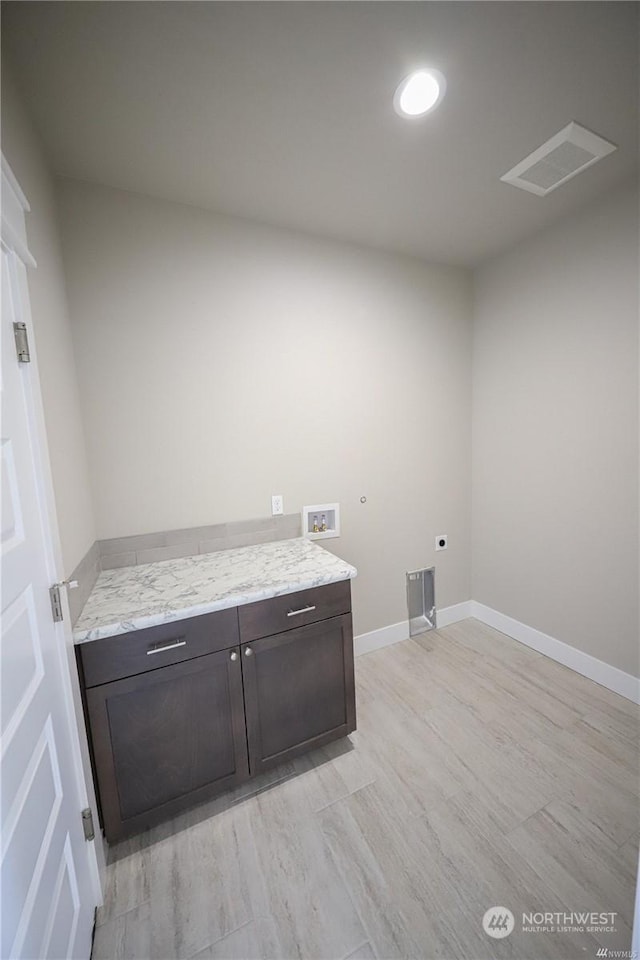 washroom with cabinet space, baseboards, visible vents, hookup for an electric dryer, and washer hookup