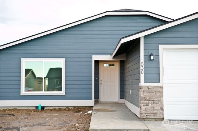 doorway to property featuring a garage