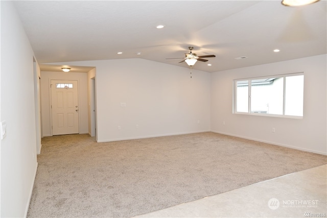 empty room with lofted ceiling, recessed lighting, a ceiling fan, and light colored carpet