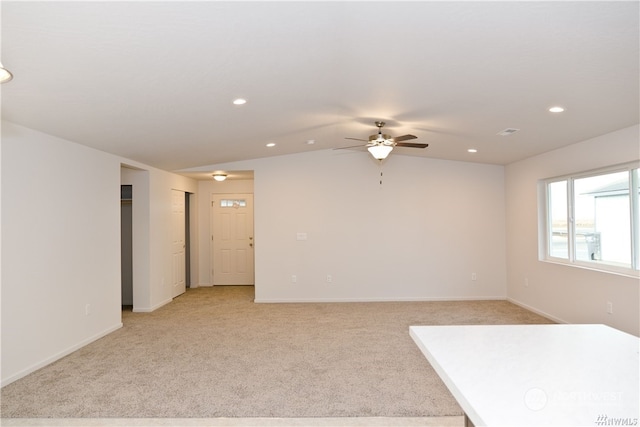 unfurnished room with light carpet, visible vents, baseboards, lofted ceiling, and recessed lighting