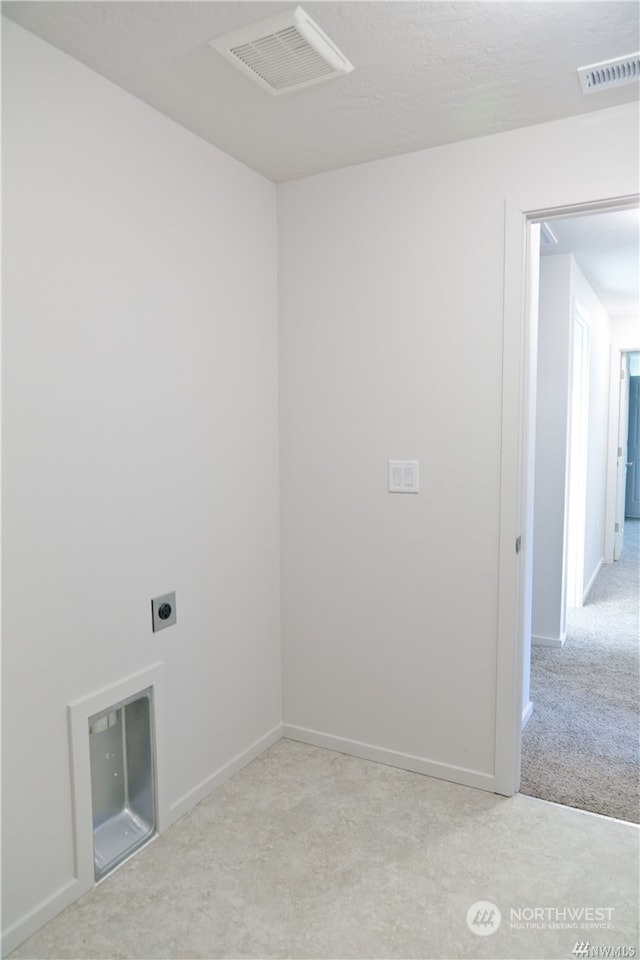 spare room with baseboards, visible vents, and light colored carpet