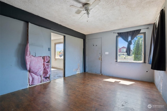 interior space featuring a textured ceiling, ceiling fan, and wood-type flooring