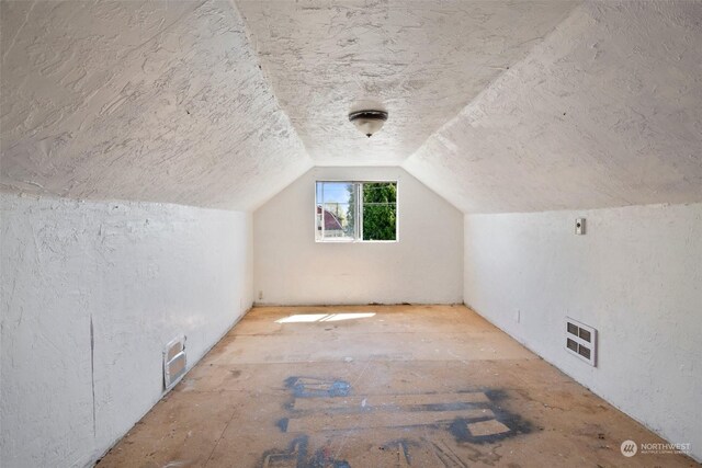 additional living space featuring vaulted ceiling