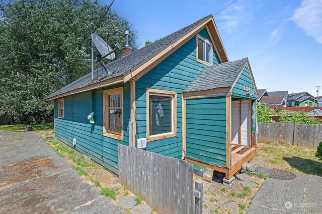 view of home's exterior with an outbuilding