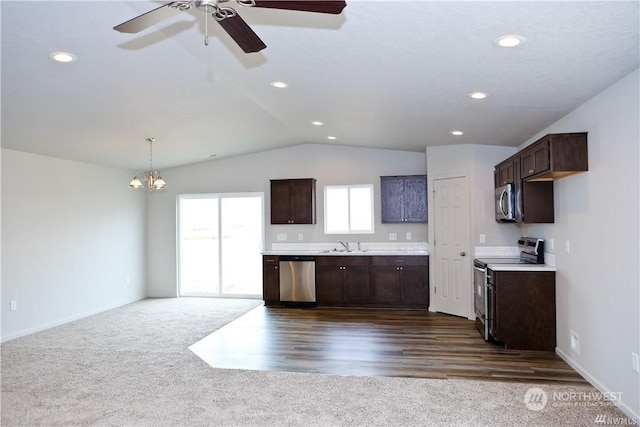 kitchen featuring stainless steel appliances, dark brown cabinets, and a sink