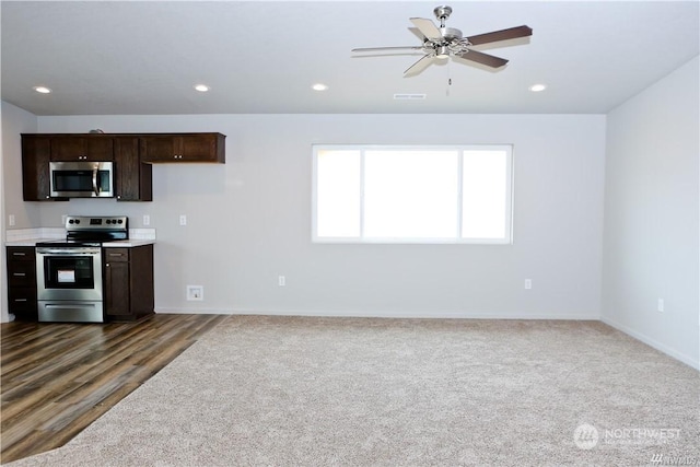 kitchen with appliances with stainless steel finishes, recessed lighting, and dark brown cabinets