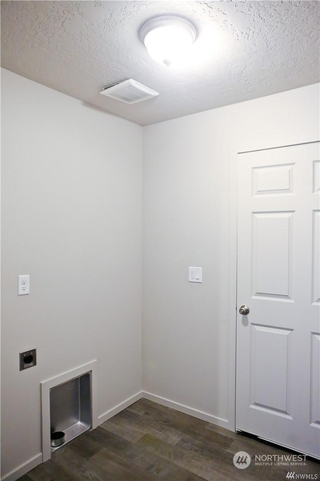 laundry area featuring dark wood-style floors, visible vents, hookup for an electric dryer, a textured ceiling, and laundry area