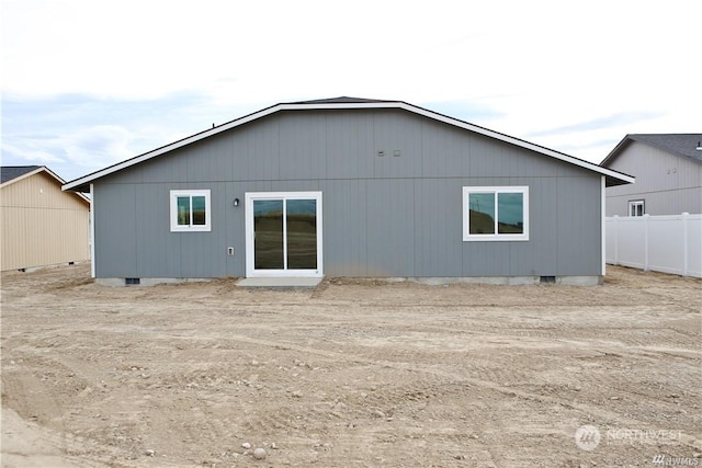 back of property with crawl space and fence