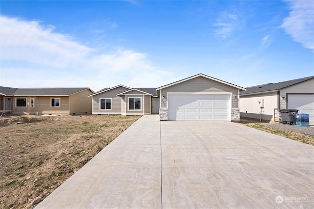 ranch-style home featuring a garage, stone siding, and concrete driveway