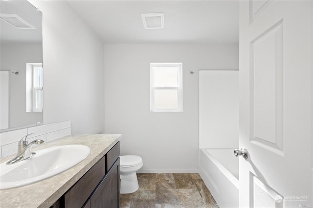 full bathroom with toilet, visible vents, a bath, and vanity