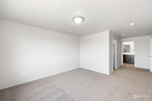 unfurnished room featuring light colored carpet and visible vents