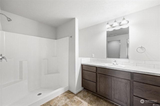 bathroom with walk in shower and vanity