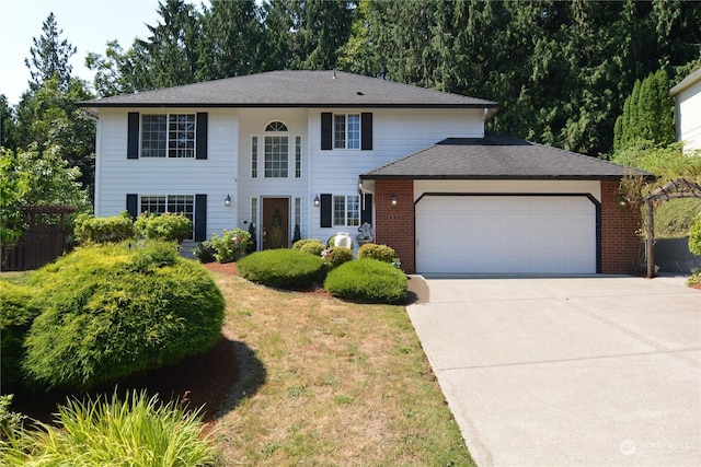 view of front of property featuring a front yard and a garage