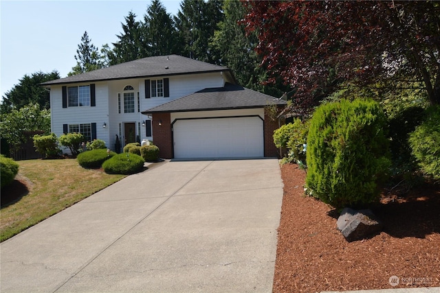 view of front of home featuring a front lawn and a garage