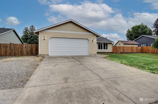 single story home with a garage and a front lawn