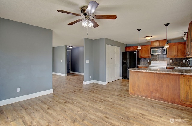 kitchen with light hardwood / wood-style flooring, hanging light fixtures, decorative backsplash, black fridge with ice dispenser, and white electric range