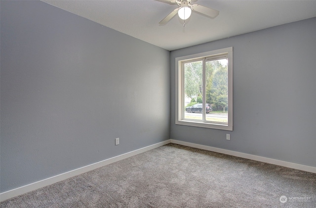 empty room featuring carpet and ceiling fan