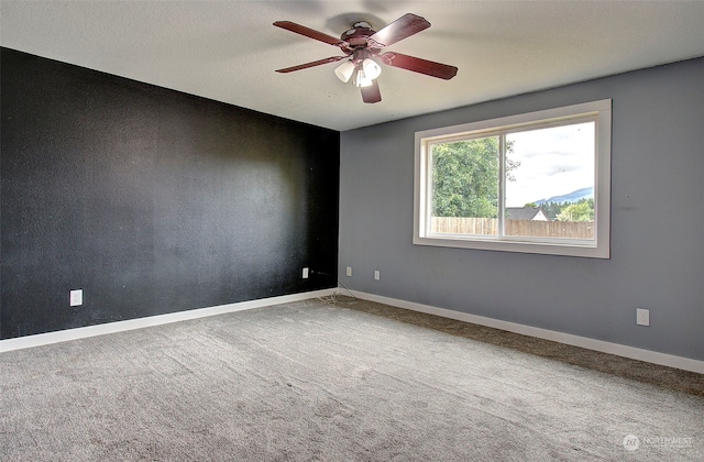 carpeted empty room featuring ceiling fan