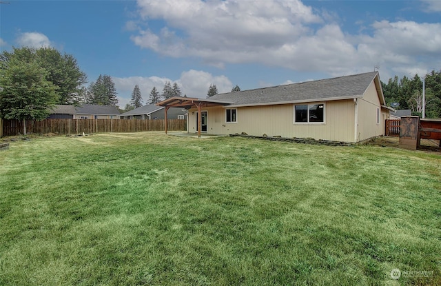 rear view of house with a yard and a patio area