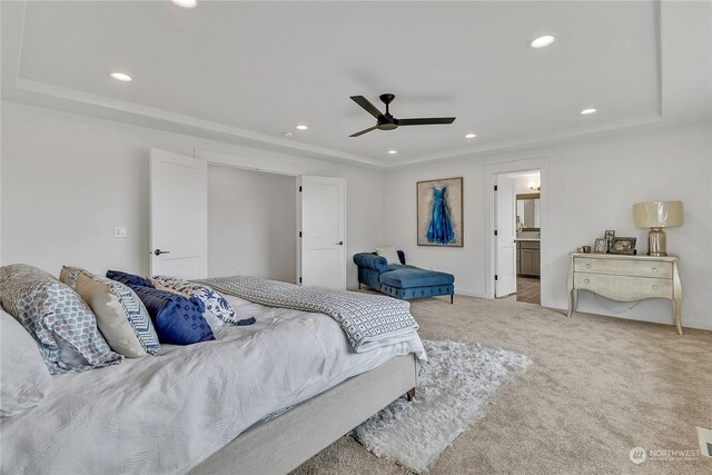 bedroom featuring light carpet, ceiling fan, a tray ceiling, and recessed lighting