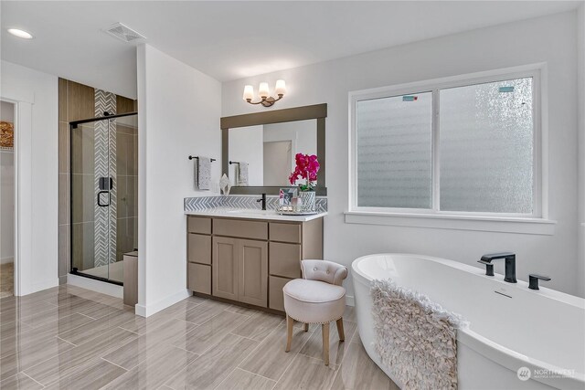 bathroom featuring a freestanding tub, wood finish floors, visible vents, vanity, and a shower stall