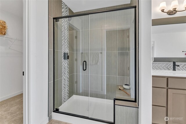 bathroom featuring vanity and a shower with shower door