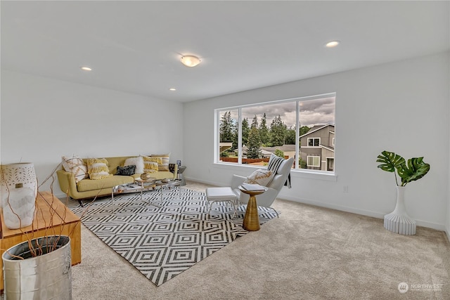 carpeted living room with recessed lighting and baseboards