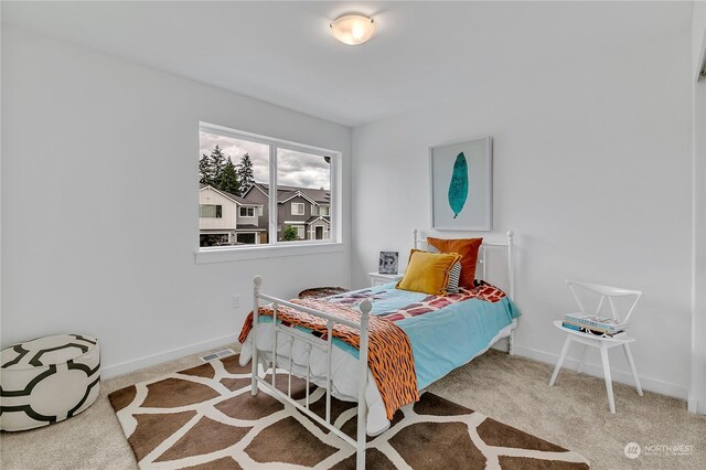 carpeted bedroom with baseboards and visible vents