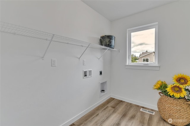 washroom featuring hookup for a washing machine, visible vents, hookup for an electric dryer, light wood-type flooring, and laundry area