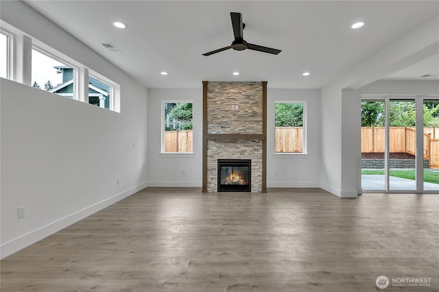 16224 76th Avenue Ct E, Puyallup, WA 98375 - unfurnished living room with healthy amount of natural light, a ceiling fan, a stone fireplace, and recessed lighting