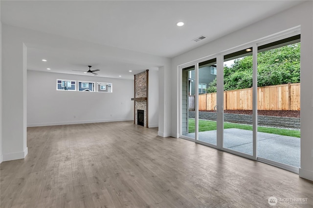 16224 76th Avenue Ct E, Puyallup, WA 98375 - unfurnished living room featuring light wood-type flooring, ceiling fan, a fireplace, baseboards, and recessed lighting