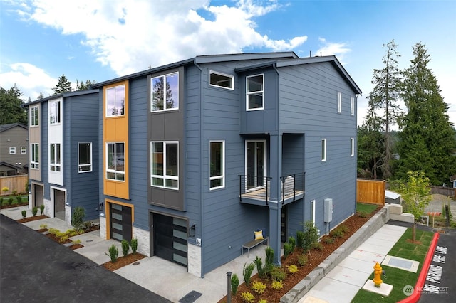 view of front of property with a garage and a balcony