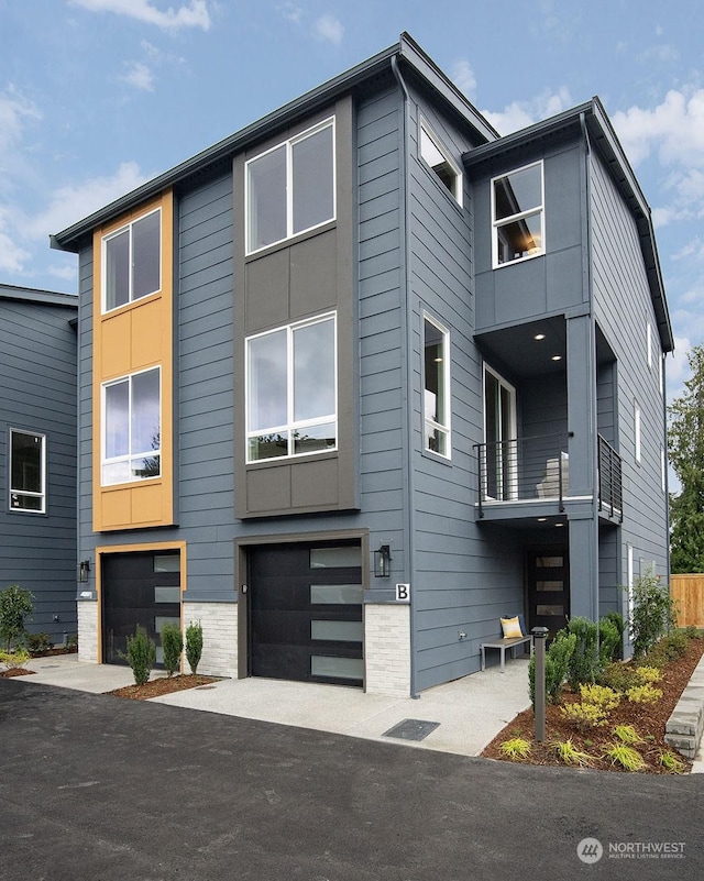 view of front of home with a balcony and a garage