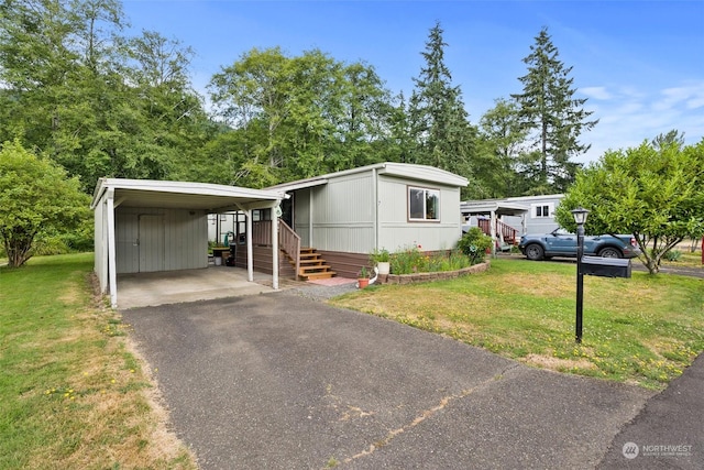 manufactured / mobile home with a carport and a front lawn