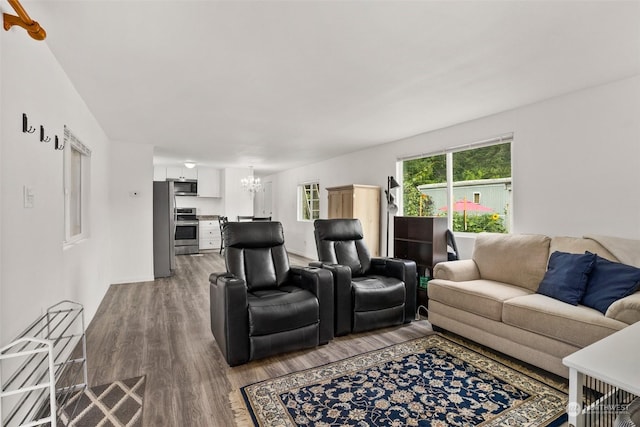 living room with hardwood / wood-style floors and a notable chandelier